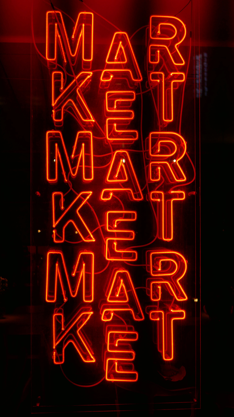 traditional marketing image of neon text on brick wall